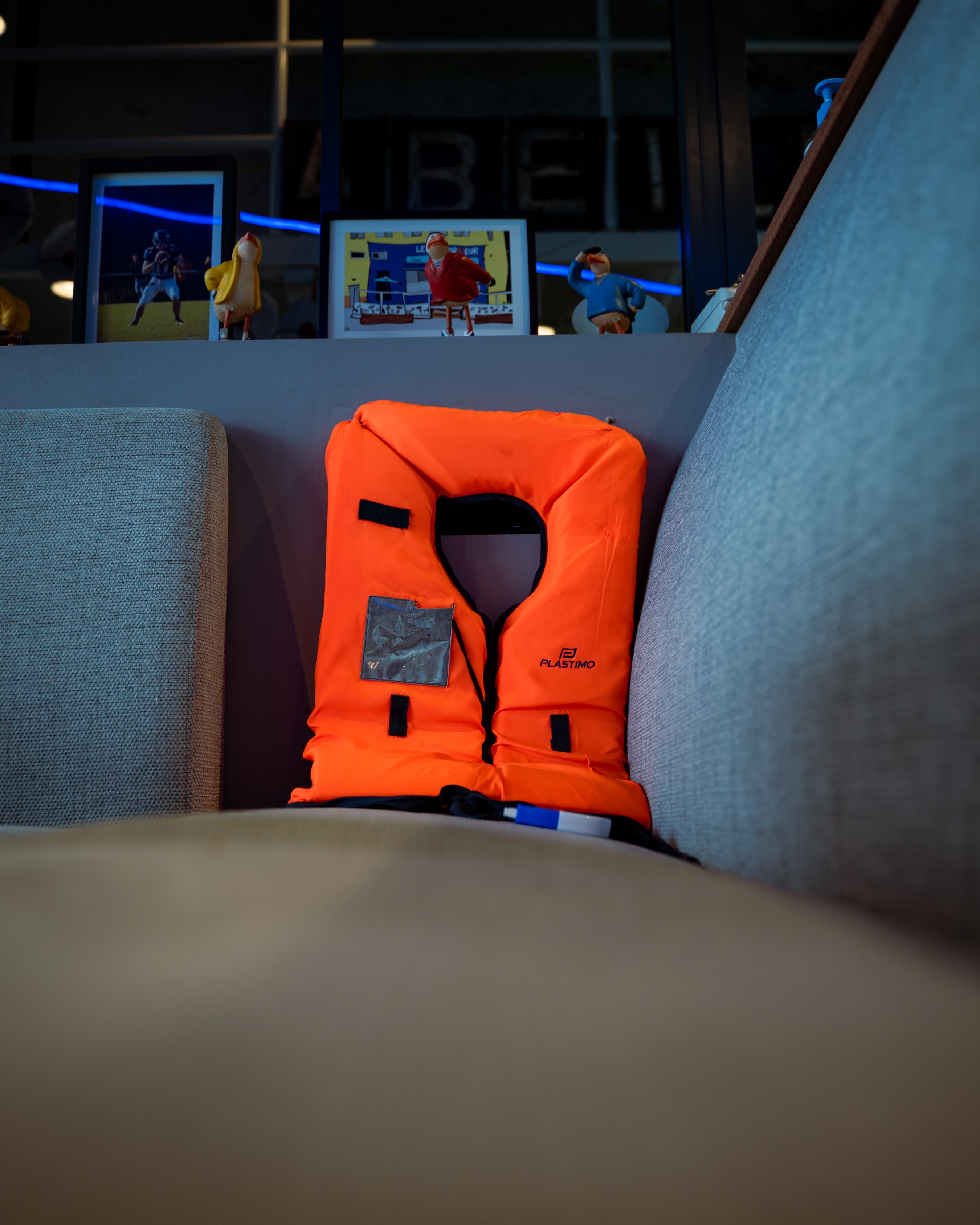 Gilet de sauvetage orange posé entre les fauteuils, clin d'œil à l'ambiance portuaire